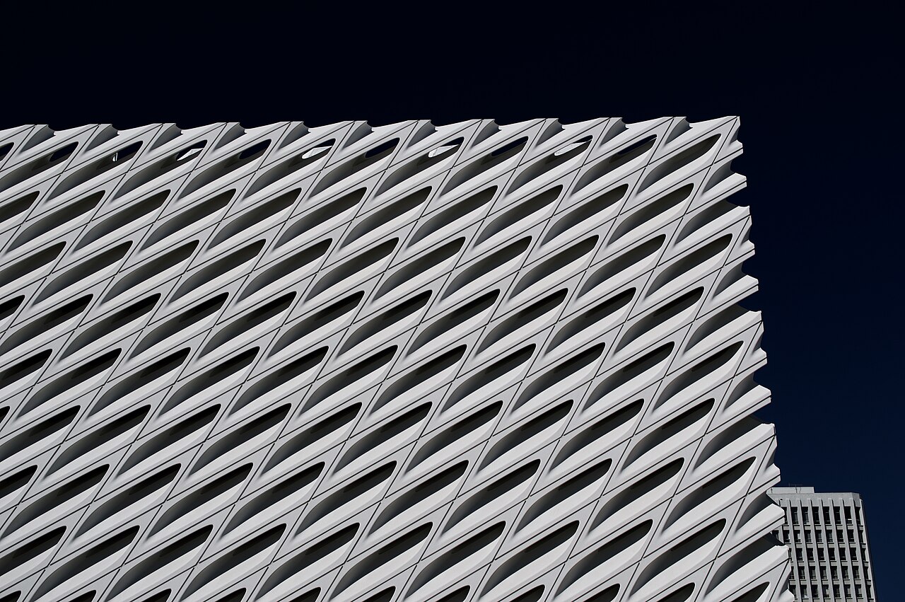 The Broad's sculptural white honeycomb facade against a dark blue Los Angeles sky